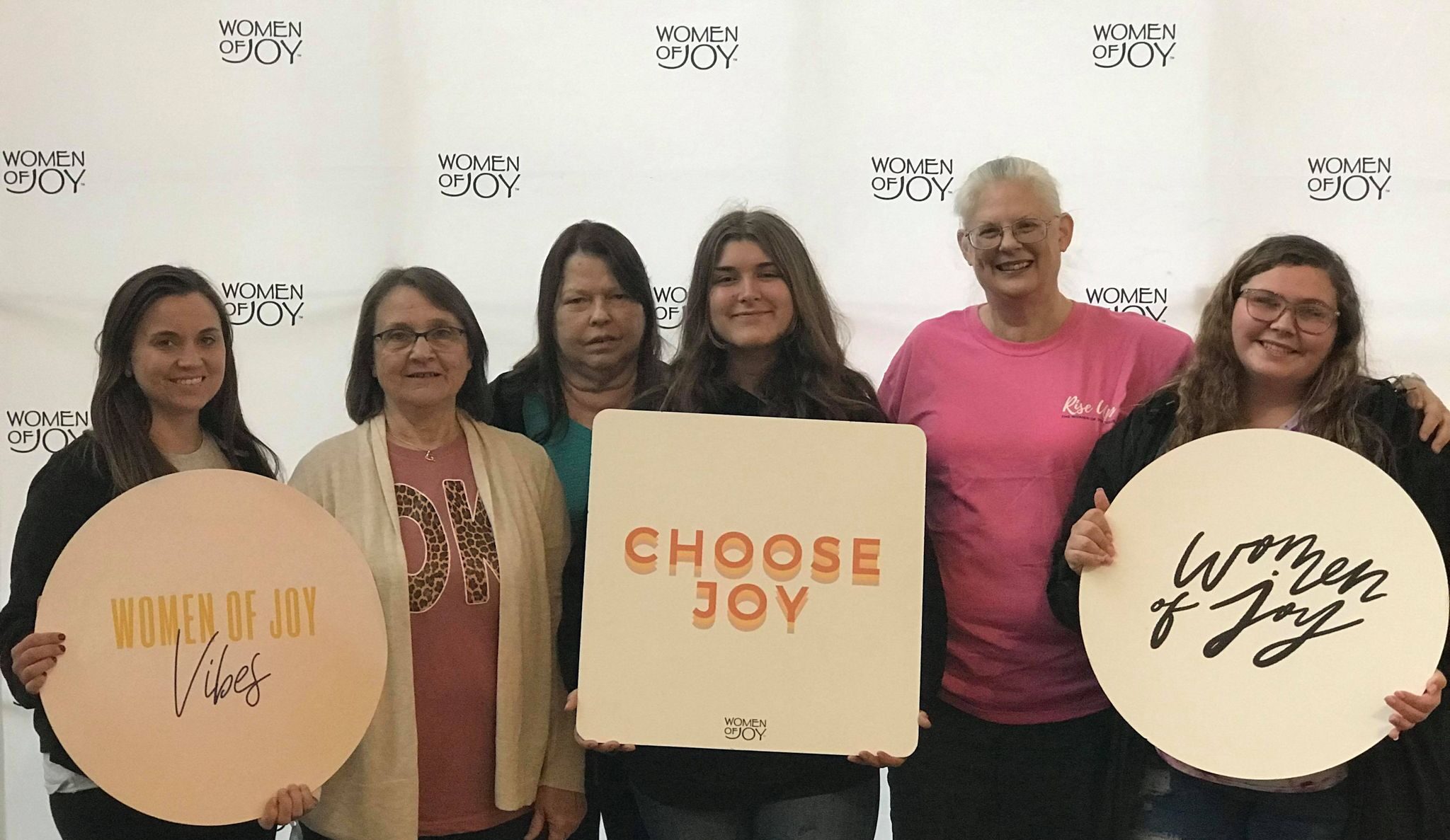 group photo of women from our church holding signs at Women of Joy