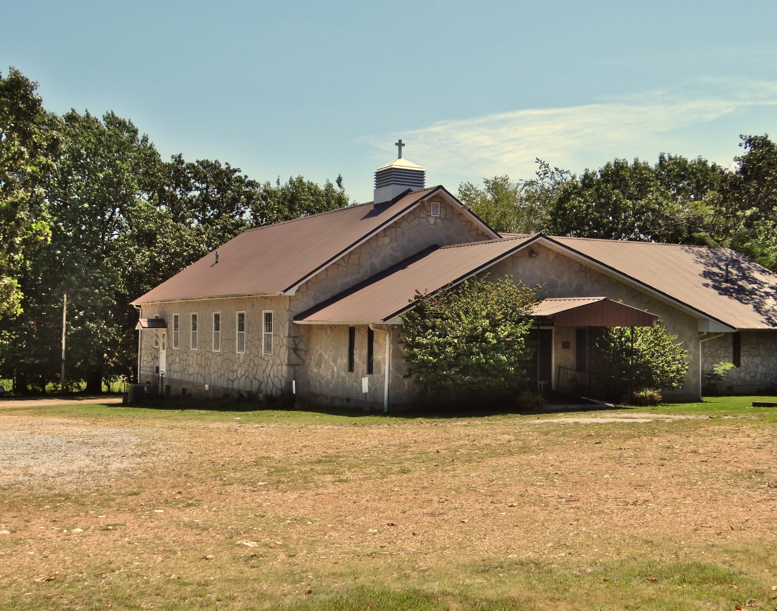 3/4 view of the church exterior in summer